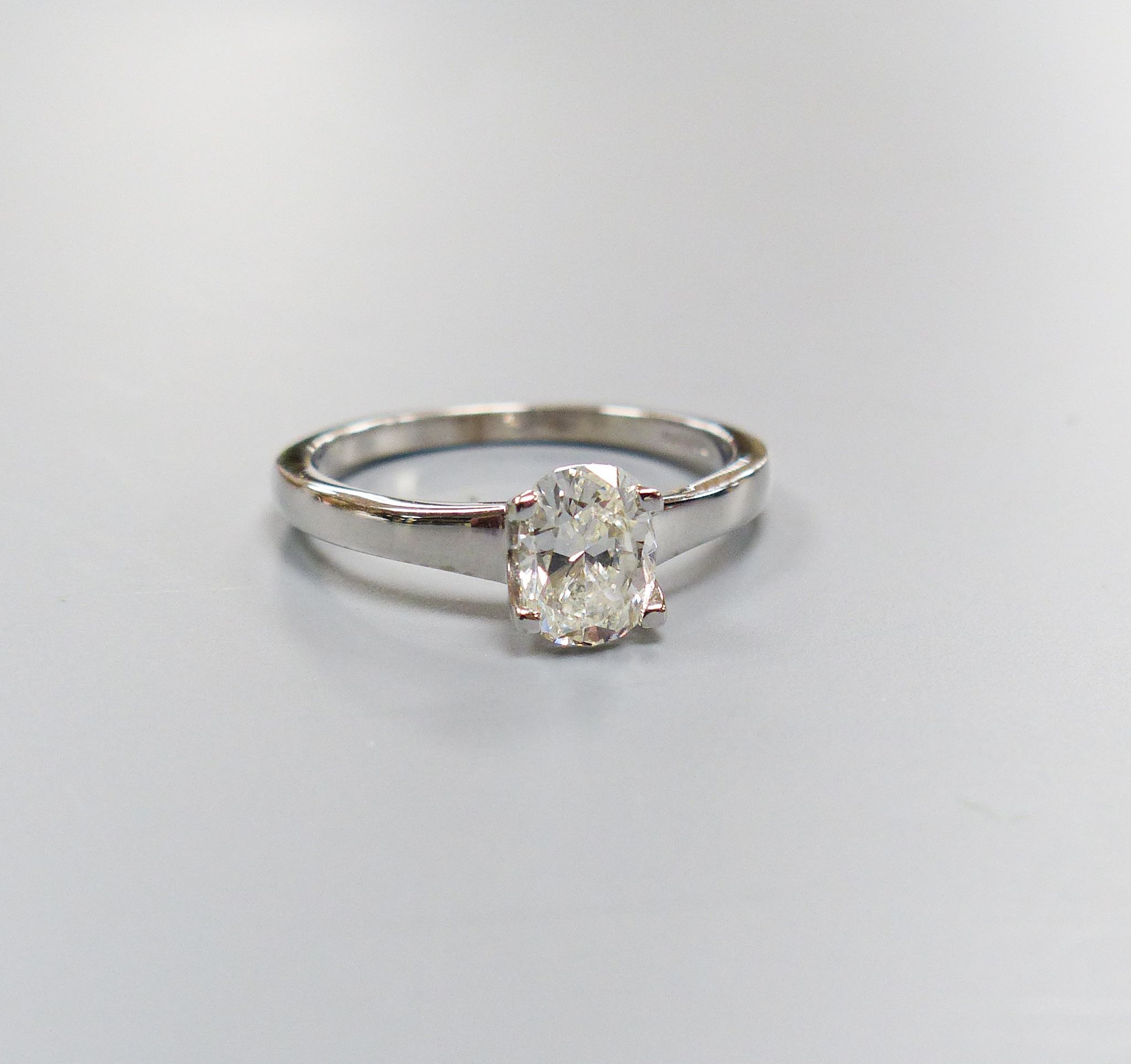 A modern 18ct white gold and solitaire oval cut diamond ring, size M, gross 3.1 grams, with GIA report dated 26/01/1999 stating the stone to weigh 0.88ct with a colour and clarity of F and SI1.